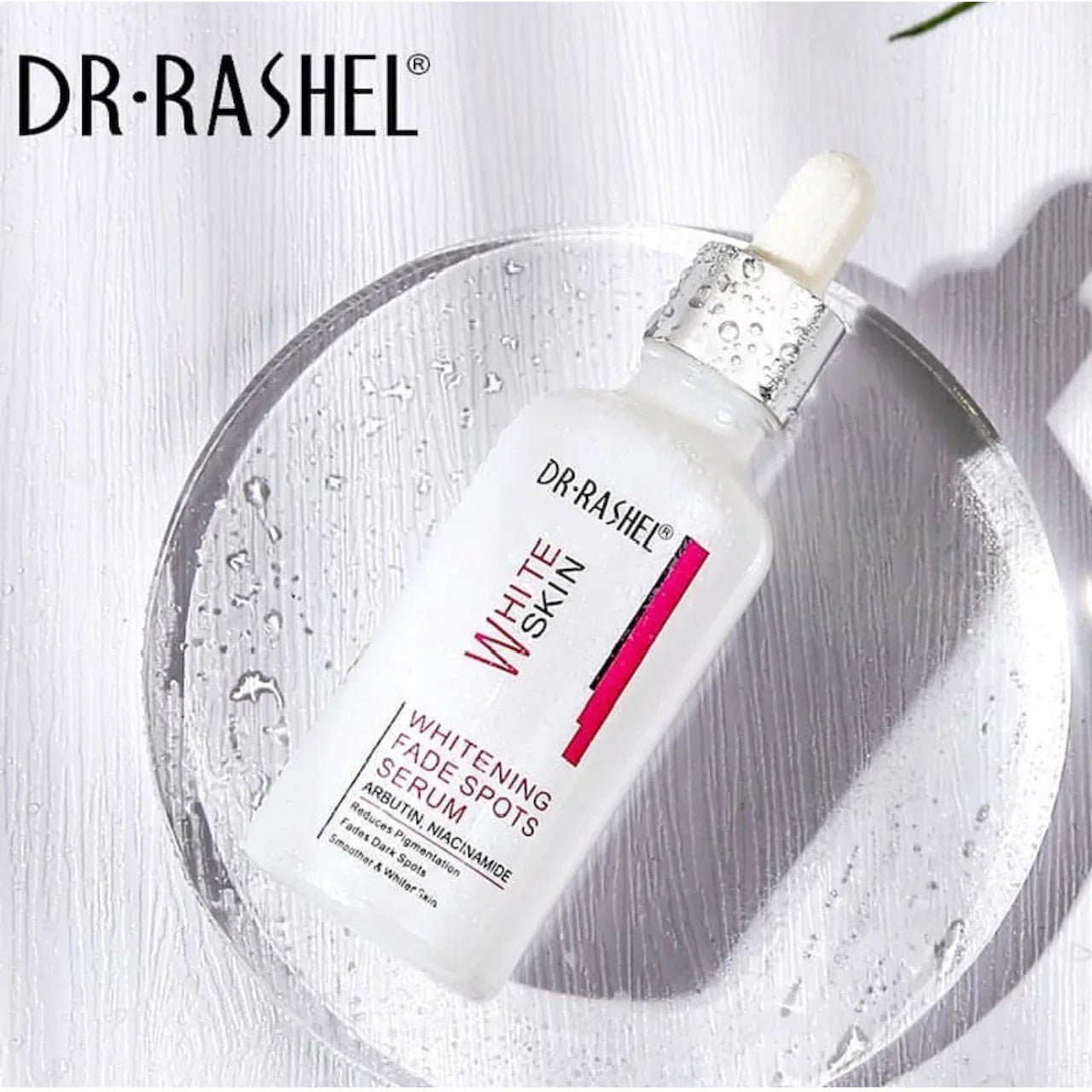 A bottle of Dr. Rashel White Skin Whitening Fade Spots Serum, with a dropper dispenser, against a white background with water droplets on the bottle and a shadow on the ground.